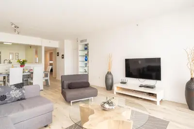 a living room with a couch and a tv at Golden Bay 1003 in Miami Beach