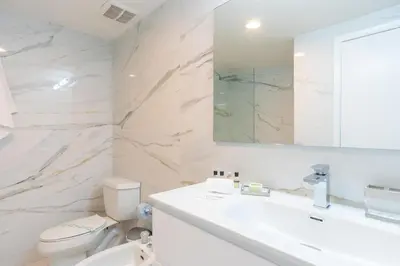 a bathroom with a sink and a toilet and a mirror at Golden Bay 502 in Miami Beach