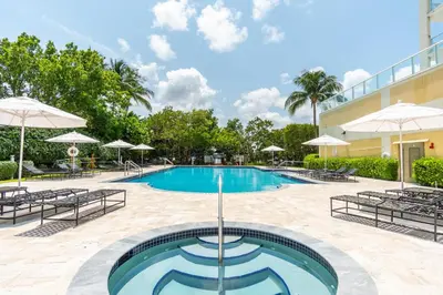 a pool at a hotel with chairs and umbrellas at Golden Bay 502 in Miami Beach