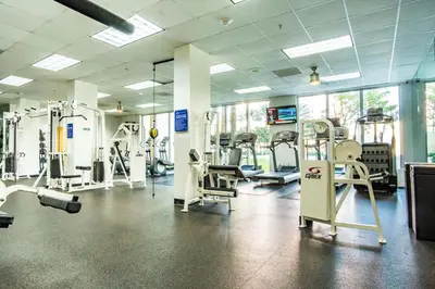 a gym with several treadmills and machines in it at Ocean Reserve 1515 in Miami Beach