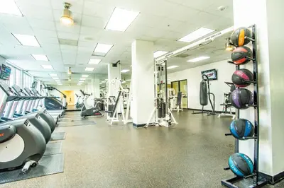 a gym with rows of treadmills and machines at Ocean Reserve 1515 in Miami Beach