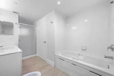 a white bathroom with a tub and a sink at Golden Bay 509 in Miami Beach