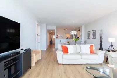 a living room with a white couch and a tv at Golden Bay 602 in Miami Beach