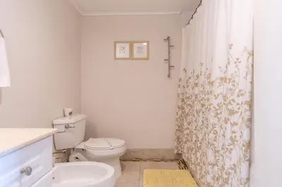 a bathroom with a toilet and a shower curtain at Golden Bay 303 in Miami Beach