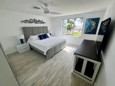 a white bedroom with a bed and a window at WOW! Best Location! Best Unit! New Renovated South Beach Ocean Front in Miami Beach