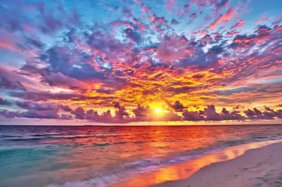a sunset on a beach with the ocean and the sky at WOW! Best Location! Best Unit! New Renovated South Beach Ocean Front in Miami Beach