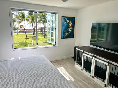 a living room with a large window and a flat screen tv at WOW! Best Location! Best Unit! New Renovated South Beach Ocean Front in Miami Beach