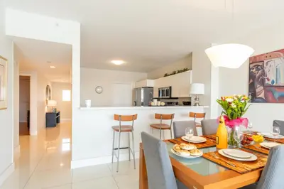 a dining room and kitchen with a table and chairs at Golden Bay 707 in Miami Beach