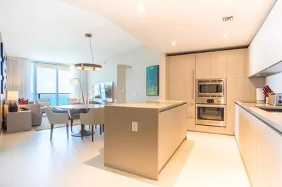 a kitchen and dining room with a table and chairs at Lyfe Beach Resort 3604 in Hollywood Beach