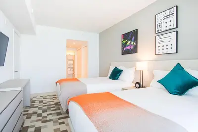 a bedroom with two beds and a tv at Lyfe Beach Resort 3604 in Hollywood Beach