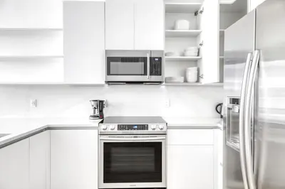 a white kitchen with a stove and a microwave at Coral Gables 1BR w WD Pool Gym nr Shops MIA-9 in Miami