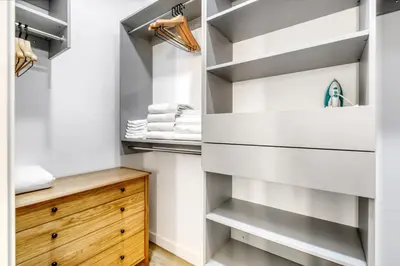 a walk in closet with white and wooden shelves at Coral Gables 1BR w WD Pool Gym nr Shops MIA-9 in Miami