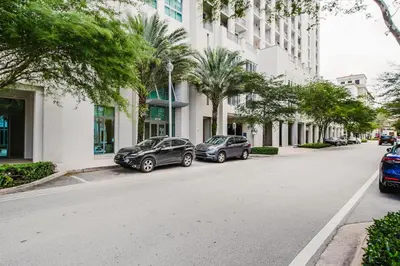 two cars parked on the side of a street with buildings at Coral Gables 1BR w WD Pool Gym nr Shops MIA-9 in Miami