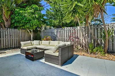 a patio with a couch and a table and a fence at Vacation Rental with Private Pool in Wilton Manors in Fort Lauderdale