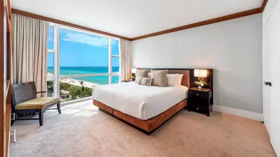 a hotel room with a bed and a large window at 1 Bedroom Private Residence at Carillon Miami Resort -911 in Miami Beach