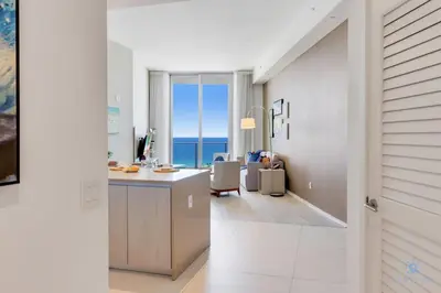 a room with a kitchen with a view of the ocean at Beachfront Condo Front Oceanview Balcony Pools in Hollywood