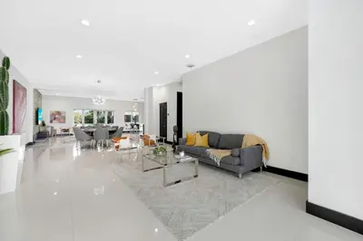 a living room with a couch and a table at Luxury home w pool by PMI in Miami
