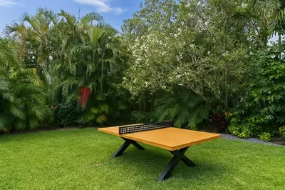 a wooden picnic table sitting in the grass at Fox Private Resort-Heated Pool, Spa-Downtown&Beach in Fort Lauderdale