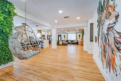 a living room with a hanging bird cage at Fox Garden-Heated Pool-Spa- Boho-Downtown & Beach in Fort Lauderdale