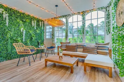 a living room with a wall of ivy at Fox Garden-Heated Pool-Spa- Boho-Downtown & Beach in Fort Lauderdale