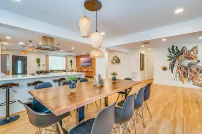 a dining room and kitchen with a wooden table and chairs at Fox Garden-Heated Pool-Spa- Boho-Downtown & Beach in Fort Lauderdale