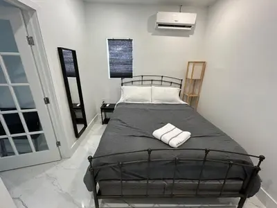 a bedroom with a bed with two towels on it at Private Rooms close to Miami Airport - Free parking - 02 in Miami