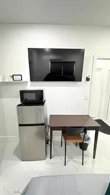 a living room with a table and a tv at Private Rooms close to Miami Airport - Free parking - 02 in Miami