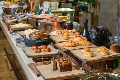 a buffet line with different types of pastries and cakes at EAST Miami Residences in Miami