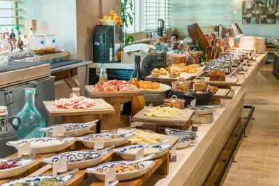 a buffet line with many plates of food at EAST Miami Residences in Miami