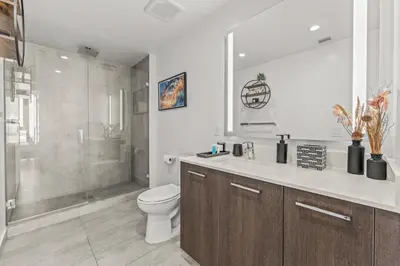 a bathroom with a toilet and a shower and a sink at Devereaux Miami 2 Bedroom, 1 Bedroom, and Studio Condos with Balconies in Miami