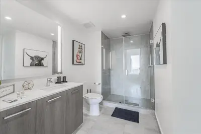 a bathroom with a toilet and a glass shower at Devereaux Miami 2 Bedroom, 1 Bedroom, and Studio Condos with Balconies in Miami