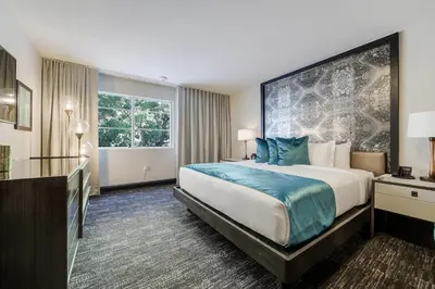 a hotel room with a large bed and a window at Venezia Hotel By At Mine Hospitality in Miami Beach