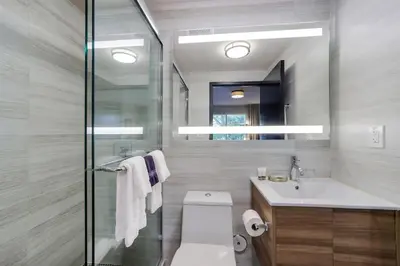 a bathroom with a toilet and a sink at Venezia Hotel By At Mine Hospitality in Miami Beach