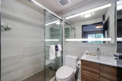 a bathroom with a toilet and a glass shower at Venezia Hotel By At Mine Hospitality in Miami Beach