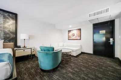 a hotel room with a bed and a couch at Venezia Hotel By At Mine Hospitality in Miami Beach