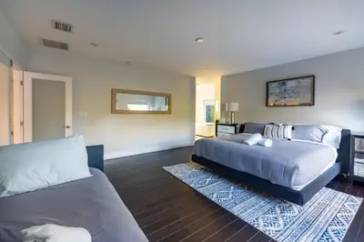 a bedroom with two beds and a couch at Fascinating Luxe Two-Level Villa BY THE GLAMHOMES in Biscayne Park