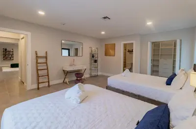 a room with two beds and a desk in it at Mega Fun Villa Northwest Miami BY THE GLAMHOMES in Miami