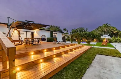a wooden deck with lights in the yard at Mega Fun Villa Northwest Miami BY THE GLAMHOMES in Miami
