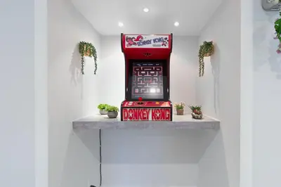 a red vending machine sitting on a shelf with plants at Cool Villa Northwest Miami BY THE GLAMHOMES in Miami