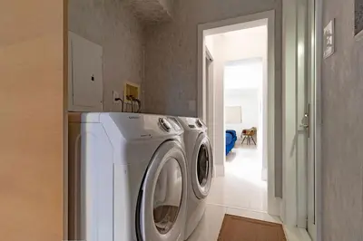 a washer and dryer in a room with a hallway at Cool Villa Northwest Miami BY THE GLAMHOMES in Miami