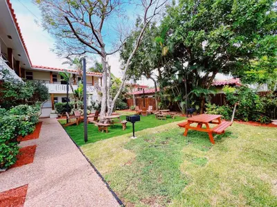 a group of picnic tables and benches in a park at The Leeward Apartments By Lowkl in Fort Lauderdale