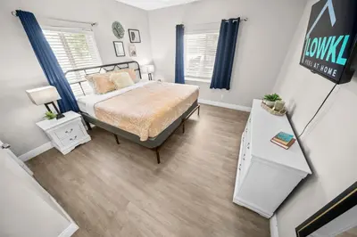 a bedroom with a bed and a sign on the wall at The Leeward Apartments By Lowkl in Fort Lauderdale