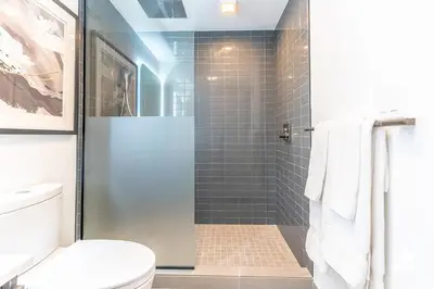 a bathroom with a shower with a toilet and a glass door at Downtown Miami Condos by Lua Host in Miami