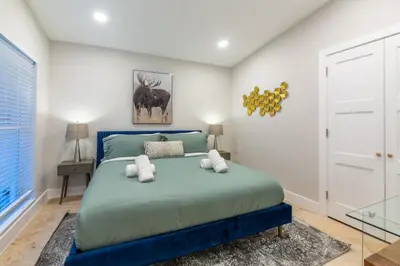 a bedroom with a blue bed in a room at Super Fun Villa Game Room BY THE GLAMHOMES in North Miami Beach