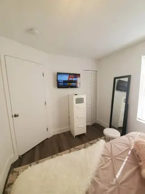 a bedroom with a bed and a tv on the wall at Lovely Apartment Near Brickell 1 in Miami