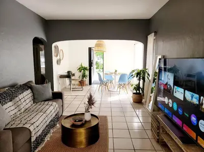 a living room with a couch and a flat screen tv at Tropical Charm Little Havana Calle Ocho 3 in Miami