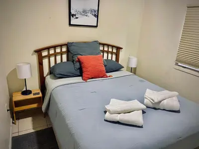 a bed with two pillows and towels on it at Private Room near Miami Airport - Free parking - 02 in Miami