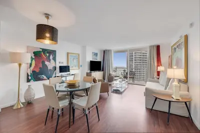 a living room with a table and chairs and a couch at Brickell Apt with Bay Views, Pool, Free Parking in Miami