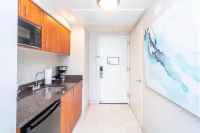 a small kitchen with a sink and a microwave at TRUMP INTERNATIONAL BEACH RESORT 2 BEDROOM APARTMENT 1600 Sf Ocean and Bay View in Miami Beach