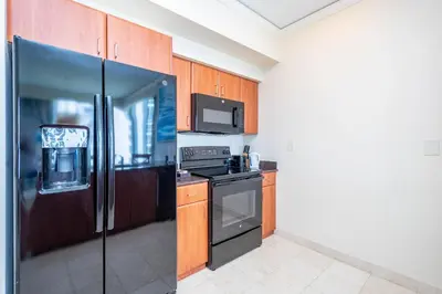 a kitchen with a refrigerator and a stove at TRUMP INTERNATIONAL BEACH RESORT 2 BEDROOM APARTMENT 1600 Sf Ocean and Bay View in Miami Beach